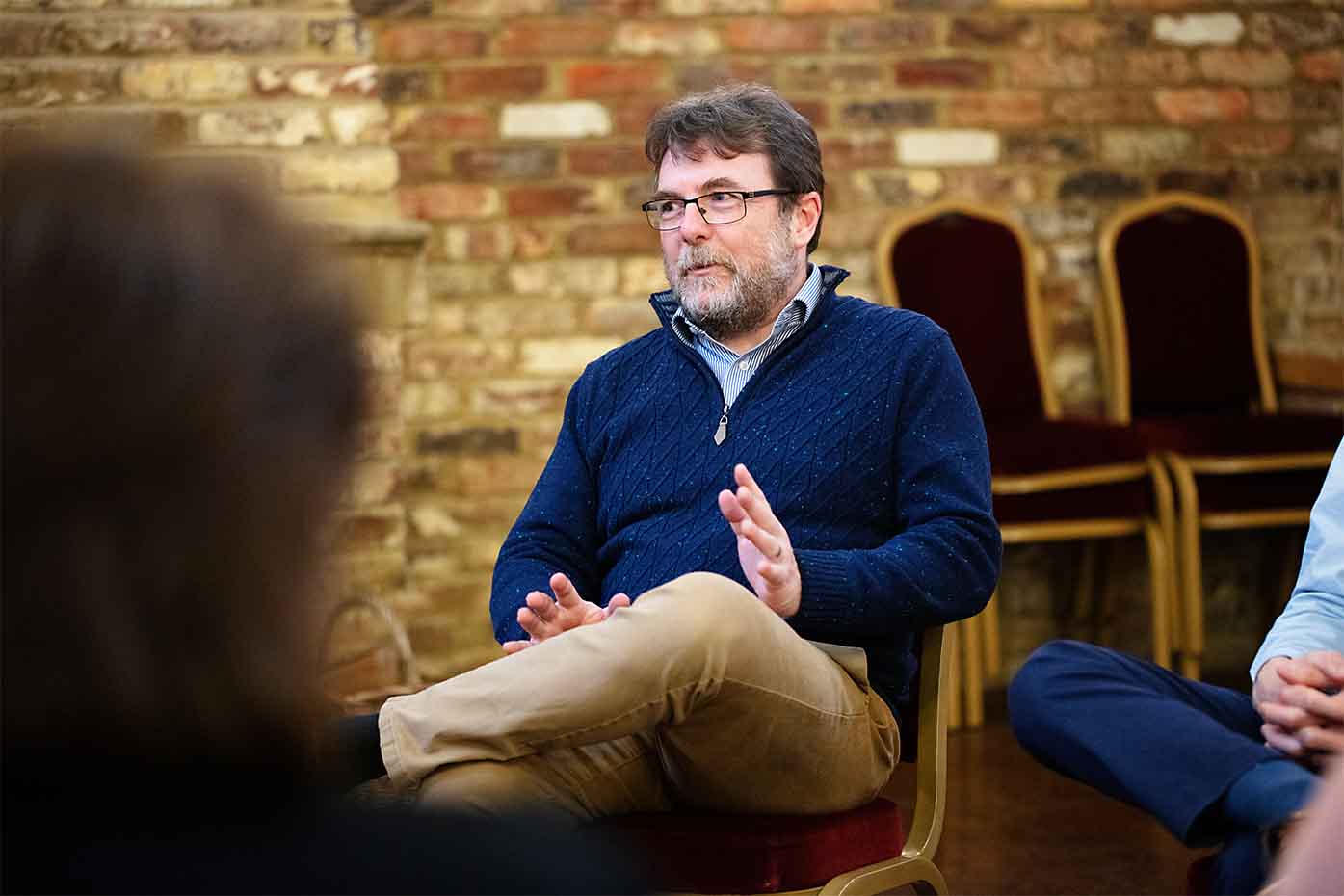 Man sat on chair in therapy session