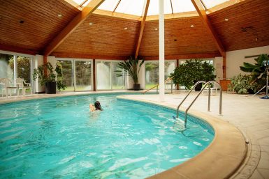 Cardinal Clinic patient enjoying a swim in the indoor heated pool