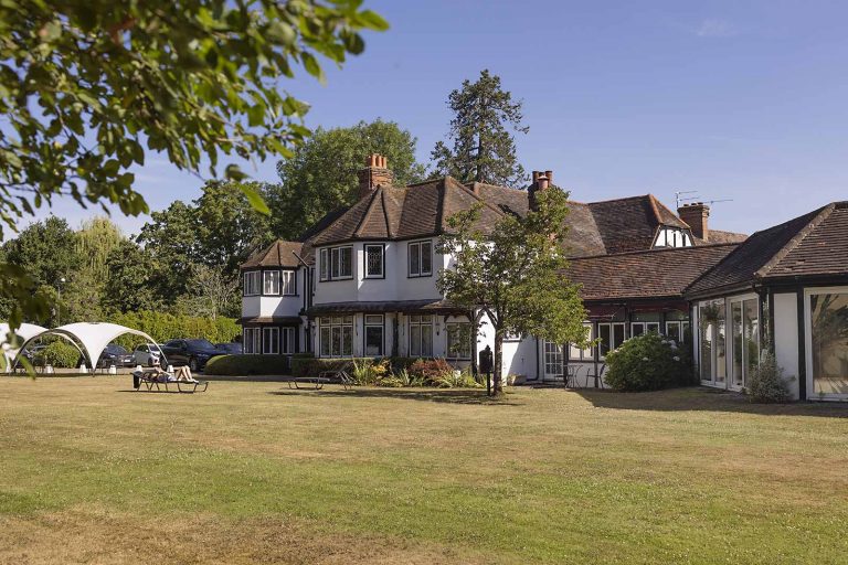 Cardinal patient relaxing with feet up in comfortable clinic lounge