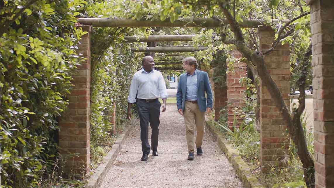 Cardinal Clinic patient and therapist walking under rose arch in private mental hospital grounds